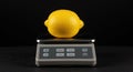 Lemon on a Digital Kitchen Scale Royalty Free Stock Photo