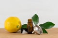 Lemon Essential Oil Bottle With Black Cap, Citrus Leaves and Funnel Royalty Free Stock Photo