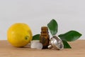 Lemon Essential Oil Bottle With White Cap, Citrus Leaves and Funnel Royalty Free Stock Photo