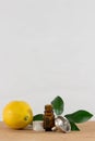 Lemon Essential Oil Bottle With White Cap, Citrus Leaves and Funnel Royalty Free Stock Photo