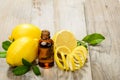 Lemon essential oil and lemon fruit on the wooden board