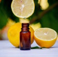 lemon essential oil and lemon fruit on a wooden white board Royalty Free Stock Photo