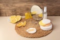 Lemon face cleanser. Fresh citrus fruits, personal care products and mirror on beige table Royalty Free Stock Photo