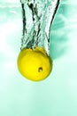 lemon falls into the water with splashes, fruit and vitamin splash