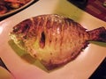 Lemon fish whole grilled on a restaran plate