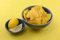 Lemon flavored plantain chips with lemon wedges