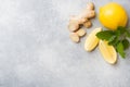 Lemon and ginger root on grey background with copy space. Ingredients for a tonic vitamin drink Royalty Free Stock Photo