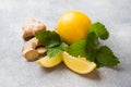 Lemon and ginger root on grey background with copy space. Ingredients for a tonic vitamin drink Royalty Free Stock Photo