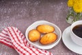 Lemon glaze madeleines on black a plate with a cup of coffee placed on a gray stone background. Madeleine - homemade traditional Royalty Free Stock Photo