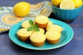 lemon-glazed gluten-free muffins on a turquoise ceramic dish