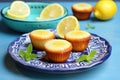 lemon-glazed gluten-free muffins on a turquoise ceramic dish