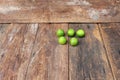 Lemon with green on the wooden table, top view