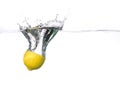 Lemon half falling into water with a splash