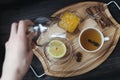 Lemon, hand, star anise, cinnamon, tea, supplement on stand