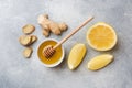 Lemon honey and ginger root on grey background with copy space. Ingredients for a tonic vitamin drink Royalty Free Stock Photo