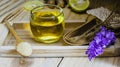 Lemon honey tea mixed with ginger in a clear glass, with a spoon and  brown sugar and hemp bag placed in a wooden tray on a brown Royalty Free Stock Photo