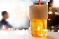 Lemon ice tea in plastic glasses on restaurant background, soft focus Royalty Free Stock Photo