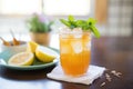 lemon iced tea in a clear cup, lemon wedge on edge, mint leaves Royalty Free Stock Photo