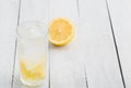 Lemon juice detox water. Mineral water infused with lemons. Wooden white table.