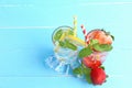 Lemon juice and strawberry juice mixing soda no alcohol in the glass garnish with mint leaves, sliced lime, and half a strawberry Royalty Free Stock Photo