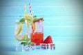 Lemon juice and strawberry juice mixing soda no alcohol in the glass garnish with mint leaves, sliced lime on blue wooden table Royalty Free Stock Photo