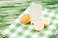 lemon juice and typical yellow sliced lemon on a green chalkboard Royalty Free Stock Photo