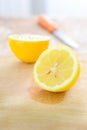 Lemon with kitchen knife on cutting board Royalty Free Stock Photo