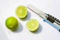 lemon and knife on a white paper.lime cutting