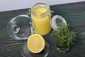 Lemon Kurd in a glass jar. Nearby is half a lemon in a container with a glass lid. A bunch of rosemary in a glass. Stand on Royalty Free Stock Photo