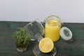 Lemon Kurd in a glass jar. Nearby is half a lemon in a glass container with a lid and a bunch of rosemary in a glass. Stand on Royalty Free Stock Photo