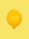 Lemon levitate in air on yellow background. Concept of fruit levitation Royalty Free Stock Photo