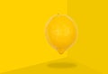 Lemon levitate in air on yellow background. Concept of fruit levitation Royalty Free Stock Photo