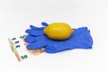 Lemon lies on a latex blue gloves on a white background, euro banknotes, money Royalty Free Stock Photo