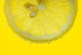 Lemon and lime drop in fizzy sparkling water, juice Royalty Free Stock Photo