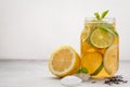 Lemon lime ice tea with mint in a glass jar, white background, c Royalty Free Stock Photo