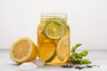 Lemon lime ice tea with mint in a glass jar, white background, c Royalty Free Stock Photo