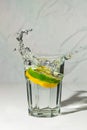 Lemon and lime water splash in glass