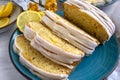 Lemon loaf sliced closeup view. Yellow cake on blue plate