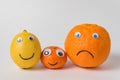 Lemon, Mandarin and orange as family. Food character with funny faces on white background