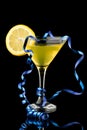 Lemon martini with blue streamer Royalty Free Stock Photo