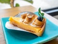 Lemon meringe cheese tart on blue dish