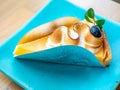 Lemon meringe cheese tart on blue dish