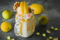Lemon milkshake drink with whipped cream, dripping sauce and yellow macaroon Royalty Free Stock Photo