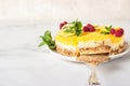 Lemon mousse vanilla cheesecake with lemon curd decorated by lemon and lime slices, frozen raspberry and mint. Royalty Free Stock Photo