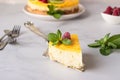 Lemon mousse vanilla cheesecake with lemon curd decorated by lemon and lime slices, frozen raspberry and mint. Royalty Free Stock Photo