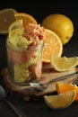 Lemon and orange ice cream scoops in glass jar