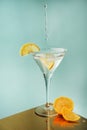 Lemon orange juice cocktail flying drops, splashes, lemon cut slices in wineglass Royalty Free Stock Photo