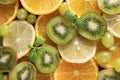 Lemon, orange ,  mint, sprig , green grapes, kiwi, on a grey ,fresh citrus and fruit, top view Royalty Free Stock Photo