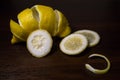 Lemon peel or lemon twist on a dark brown wooden background. Lemon slices are cut across. Close up. Royalty Free Stock Photo