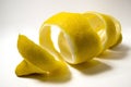 Lemon peel or lemon twist on white background. Close-up. Royalty Free Stock Photo